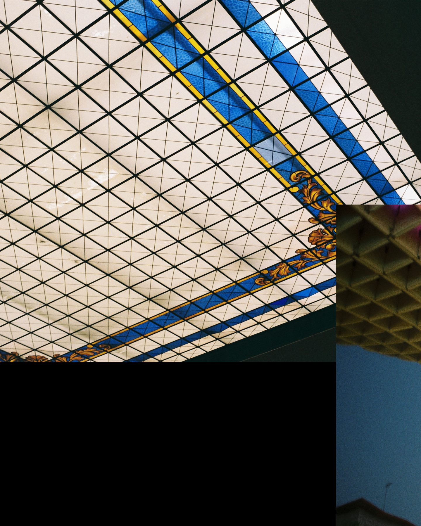 Slide 1 of 3: a stained glass skylight with blue and gold bands, and the edge of a lattice canopy lit pink