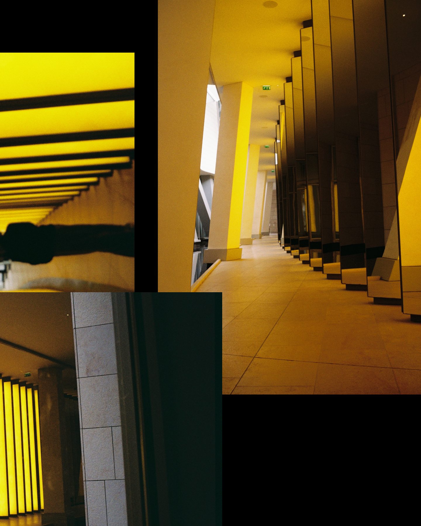Slide 2 of 2: a long hallway lit yellow between tall columns